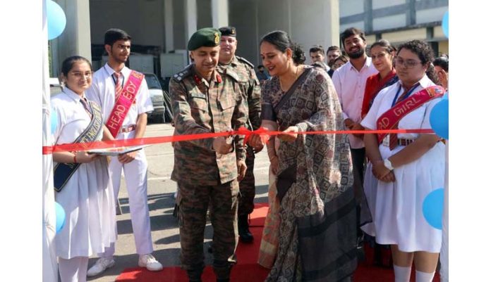 Dignitary cutting ribbon during inaugural event on Saturday.