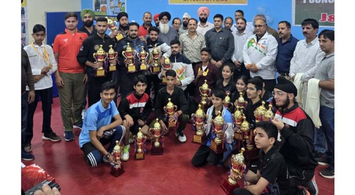 Winners posing along with trophies at Poonch.