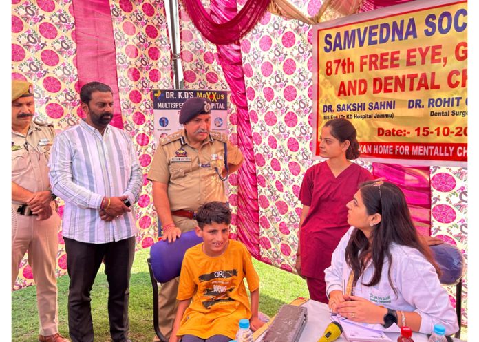 DIG JSK Range Shiv Kumar Sharma interacting with a doctor during a health check up camp in Jammu.