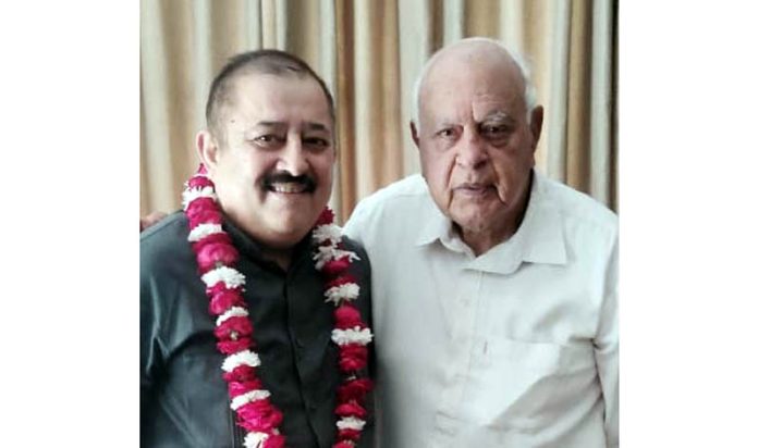 Rajesh Gupta posing with Dr Farooq Abdullah after joining the party in Jammu on Tuesday.