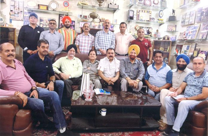 Newly elected office bearers of Basketball Association of J&K along with others pose for a group photograph.