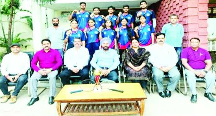 Badminton teams of Govt. SPMR College posing along with management.