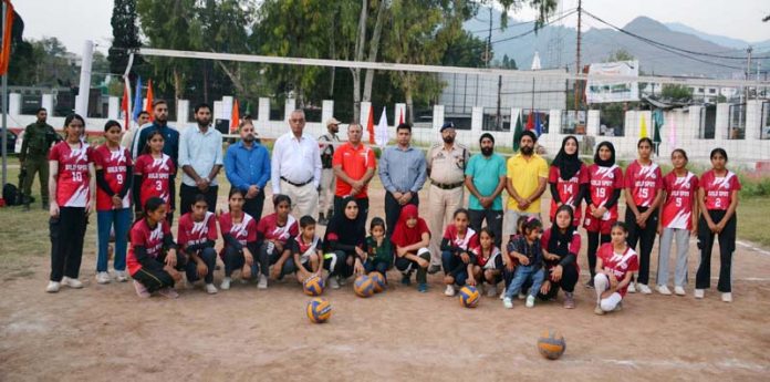 Volleyball players posing along with dignitaries at Poonch.