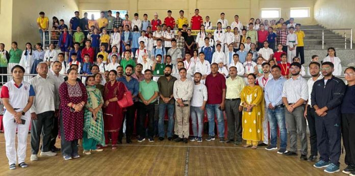 Athletes posing along with dignitaries during championship.