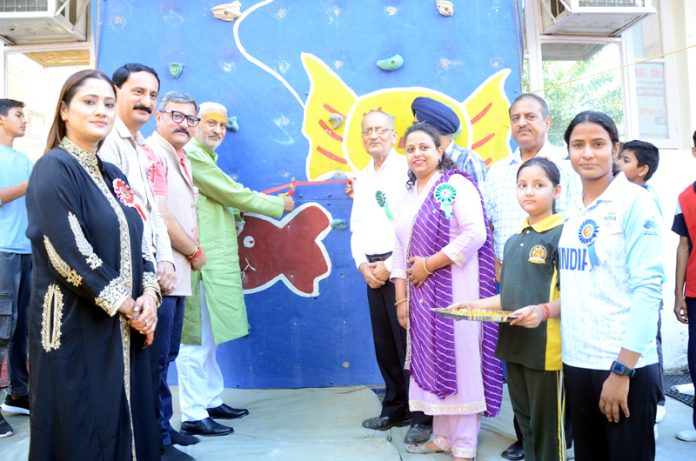 Excelsior Sports Correspondent Jammu, Oct 25: Former Minister and MLA North Jammu, Sham Lal Sharma, inaugurated the 24th J&K UT Sport Climbing Championship at the Tenzing Norgay Sport Climbing Wall, Sprawling Buds ICSE School, here today. Organized by the Mountaineering Association of J&K, the championship has drawn over 400 climbers from across the region. Sharma emphasized the urgent need for expanded sports infrastructure in Jammu, highlighting his commitment to pursuing the development of a new stadium for the growing population. He acknowledged the Government of India's active role in supporting sports in J&K and praised the Mountaineering Association's efforts to promote adventure sports in the Union Territory. He also expressed optimism that the newly built climbing wall at MA Stadium would soon be handed over to the association after updates to meet international standards. Mountaineering Association President Zorawar Singh Jamwal stressed the need for sports facilities to prevent youth from falling prey to drugs, urging the Government to expedite the handover of climbing facilities to promote international-level climbers. The opening day saw fierce competition among Sub Junior Boys and Girls, with semifinal results expected by evening. Dignitaries present included Zorawar Singh Jamwal, Ram Khajuria, Shawetica Khajuria, and officials from district mountaineering associations. Observers from the J&K Sports Council, including Divisional Sports Officer Baljinder Pal Singh, attended the event. The two-day championship promises to advance youth engagement in climbing and adventure sports in the region.