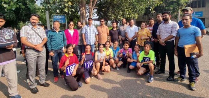 Participants posing along with dignitaries during Inter-Collegiate Cross Country Race at Jammu University.