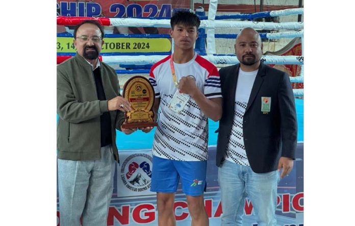 Dignitaries presenting memento to a boxer. -Excelsior/Basharat Ladakhi