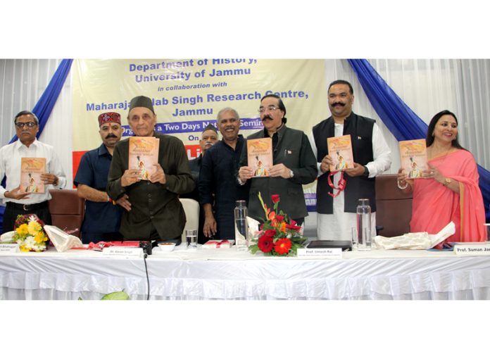 Dr Karan Singh along with other members of the royal family releasing a book on Maharaja Ranbir Singh during a function at JU on Tuesday.—Excelsior/Rakesh