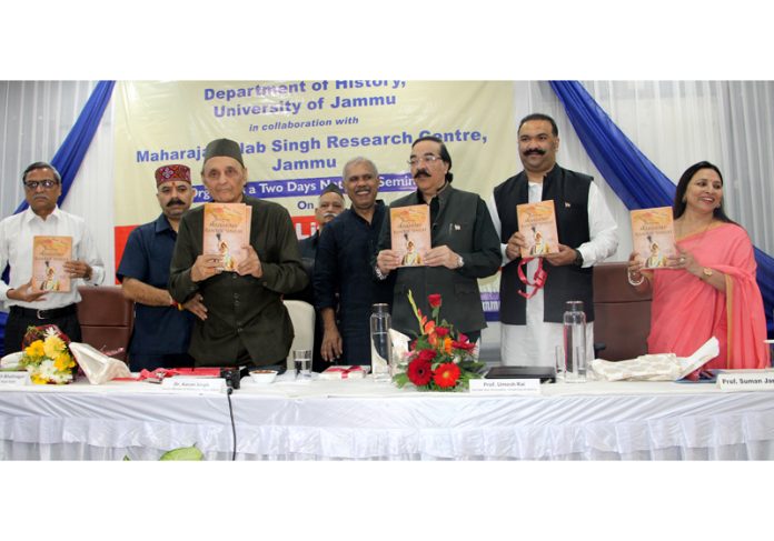 Dr Karan Singh along with other members of the royal family releasing a book on Maharaja Ranbir Singh during a function at JU on Tuesday. —Excelsior/Rakesh