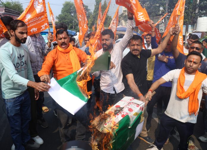 Bajrang Dal activists burning Pakistan flags during a protest in Jammu on Monday.