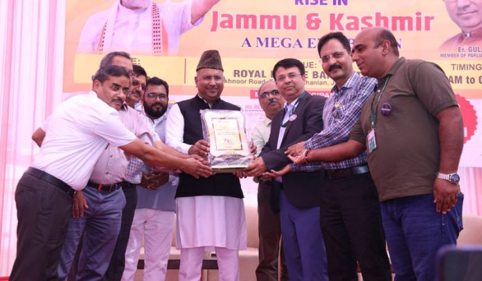 MP Rajya Sabha, Gulam Ali Khatana being presented a memento at an exhibition held in Royal Estate Resort, Akhnoor road on Saturday.