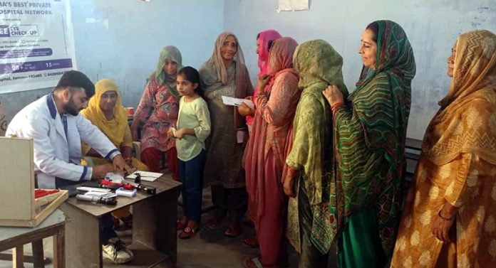 Women waiting for their turn to get vision check-up and cataract screening during free medical camp.