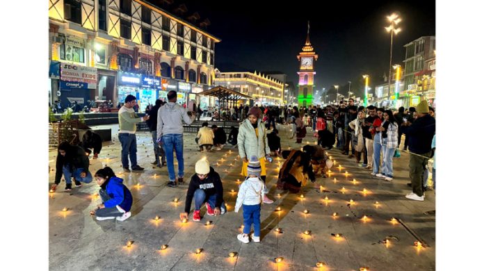 Hindu devotees light ‘diyas’ near the clock tower at Lal Chowk, Srinagar to celebrate Diwali on Thursday. - Excelsior/Shakeel