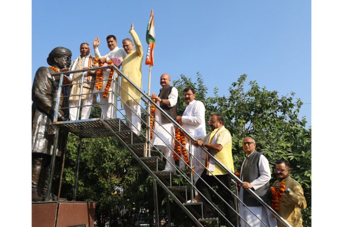 J&K BJP working president Sat Sharma along with other party leaders garlanding the statue of Pt Prem Nath Dogra in Jammu. -Excelsior/Rakesh