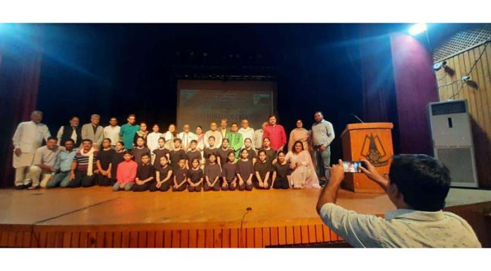 The artists along with the organizers posing for a group photograph during a function organised in Srinagar on Thursday.