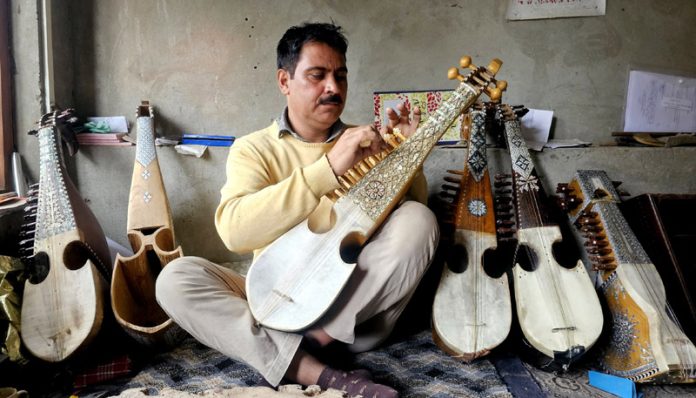 Mushtaq Ahmad Dar a third generation Rabab maker at his workshop in Narbal area of Central Kashmir's Budgam district. - Excelsior/Shakeel