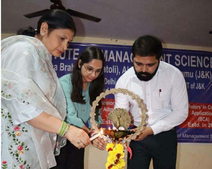 Guests lighting ceremonial lamp during inaugural of induction programme by IMS for BBA and BCA students.