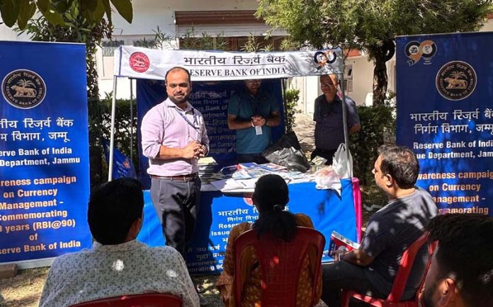 An RBI official educating people on security features of currency notes during a camp in Katra.