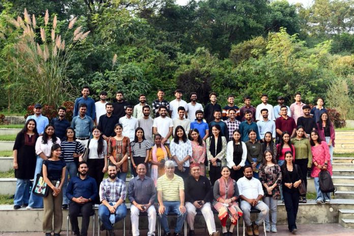 Dignitaries posing along with students of IIMC.