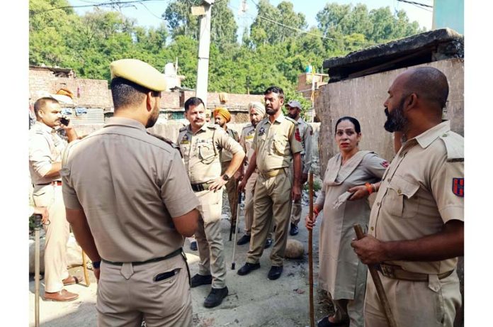 Jammu & Kashmir police conducting a raid on suspected drug hotspots at Rajeev Nagar in Jammu on Thursday. (UNI)