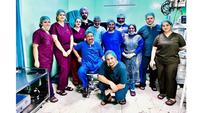 The surgical team of the Department of ENT and Head & Neck Surgery, ASCOMS Jammu posing after performing total maxillectomy on a patient.