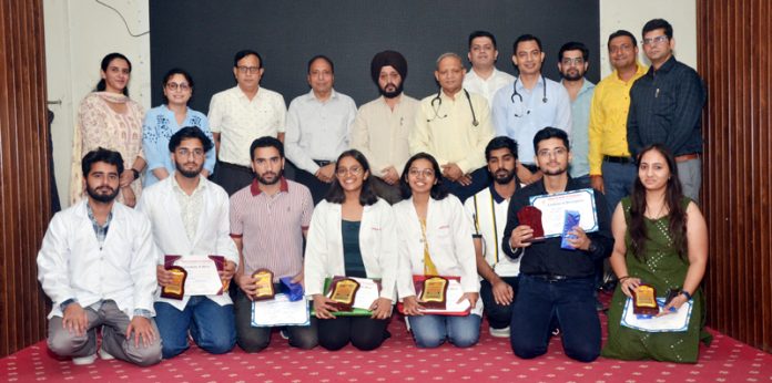 Winners and runner ups of Divisional Round of IAP Quiz posing with guests and dignitaries at ASCOMS Jammu.