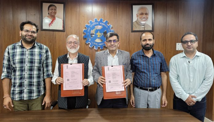 Director CSIR-IIIM and MD HAPICO displaying copies of MoU.