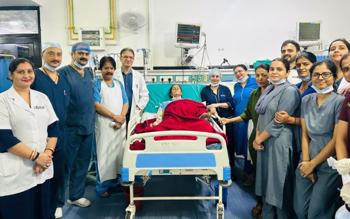 A team of doctors and OT staff posing with a patient on whom they performed open heart surgery in SSH Jammu.