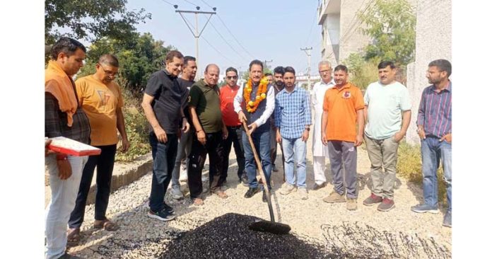 Senior BJP leader KD Singh inaugurating blacktopping of a road in Jammu on Sunday.