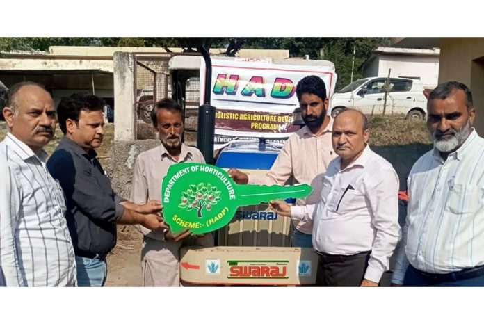 Director Horticulture CL Sharma handing over key of farm machinery to a beneficiary.