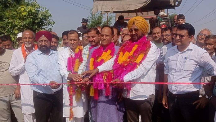 MLA Prof Garu Bhagat along with Congress leader Taranjit Singh Tony inaugurating blacktopping of a road in Suchetgarh on Thursday.