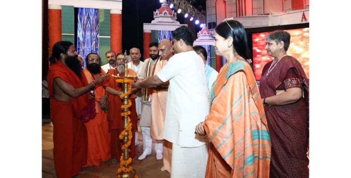 Yoga Guru Baba Ramdev and others lighting ceremonial lamp during 12th annual day of Acharyakulam in Haridwar.