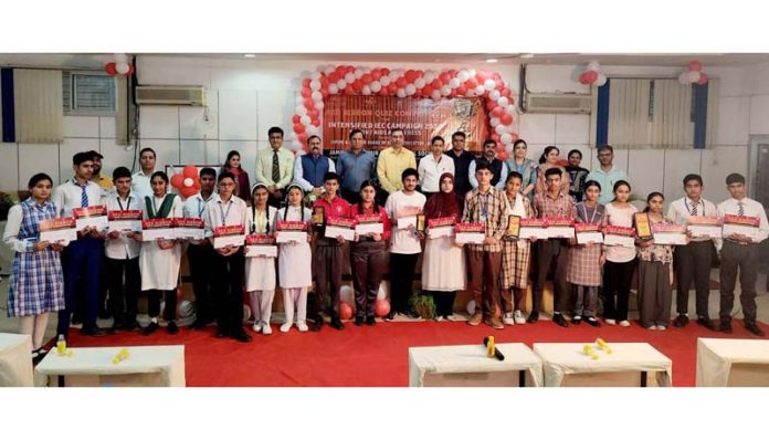 Students posing along with certificates during a Quiz Competition at Jammu.