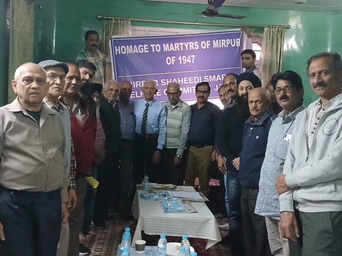 Mirpuries posing for a group photograph after paying tribute to the martyrs of Mirpur city.