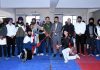 Gatka players pose for a photograph along with others at a district level competition in Jammu on Tuesday.