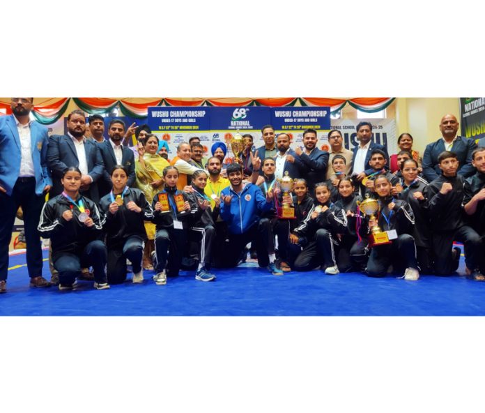 Winners displayiing their trophies and medals on culmination of Wushu Championship in Jammu on Tuesday.