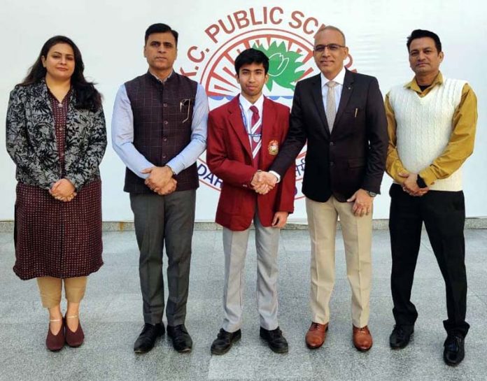 Naveen Gupta of Class 11 at KC Public School poses for a photograph with his teachers.