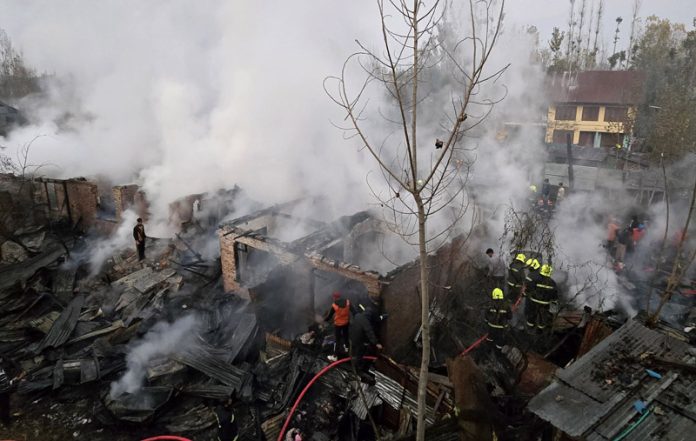 Fire & Emergency personnel dousing flames after fire broke out in Naidyar area of Rainawari in Srinagar on Tuesday. -Excelsior/Shakeel