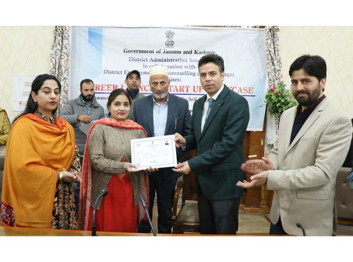 DC Srinagar presenting certificate to a beneficiary during Career Launch and Startup Showcase event at Srinagar on Friday.