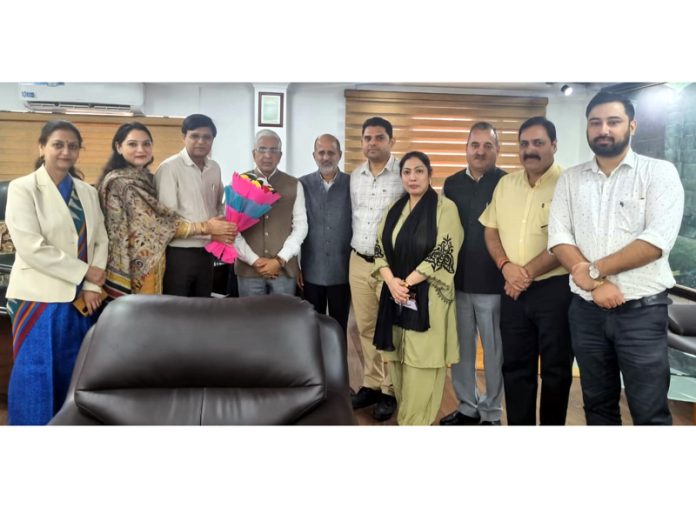 JUOWA members greeting Vice Chancellor Prof Umesh Rai with a flower bouquet in his office chamber on Monday.