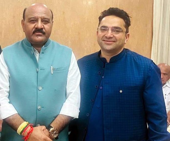 NC's Trade and Industry leader Vikram Puri interacting with Deputy Chief Minister Surinder Choudhary in Jammu on Monday.