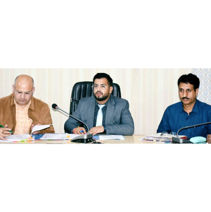 DC Rajouri Abhishek Sharma chairing a meeting on Monday.