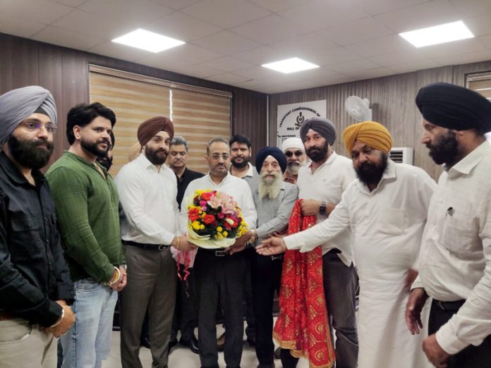 Karan Singh Wazir, Chairman of AJKTWA along with others presenting a bouquet to Divisional Commissioner in Jammu on Monday.