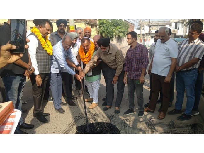 MLA Bahu, Ch Vikram Randhawa kickstarting blacktopping of road on Saturday.