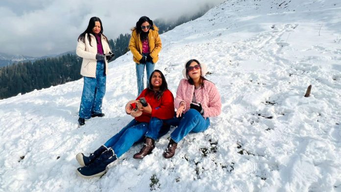 Tourists from Mumbai enjoying season’s first snowfall at Guldanda in Bhaderwah on Sunday. -Excelsior/Tilak Raj