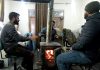 Employees warming up themselves in a office on Wednesday morning after Srinagar records season's first subzero temperature. -Excelsior/Shakeel