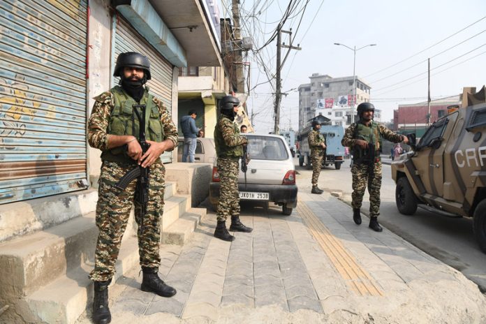 Security men on alert during gun battle at Khanyar, Srinagar on Saturday. —Excelsior/Shakeel