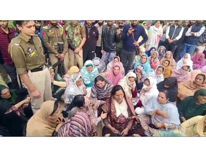 Locals during a sit-in at Kishtwar demanding proper investigation into the killing of a lady and her two minor children in a fire incident. -Excelsior/Tilak Raj