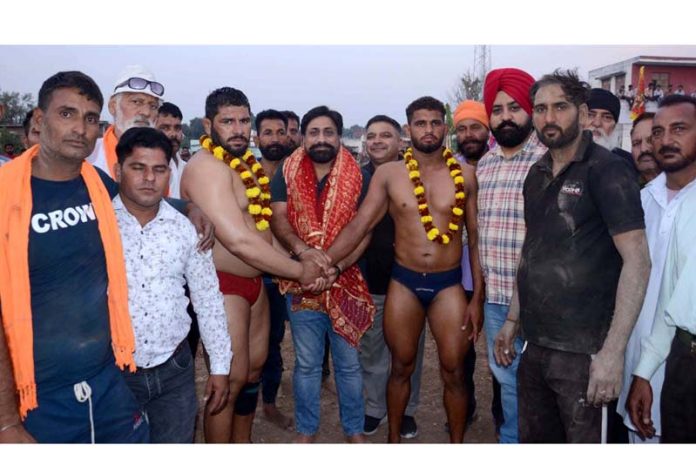 Chief guest introducing wrestlers before bout at Khandwal Panchayat on Sunday.