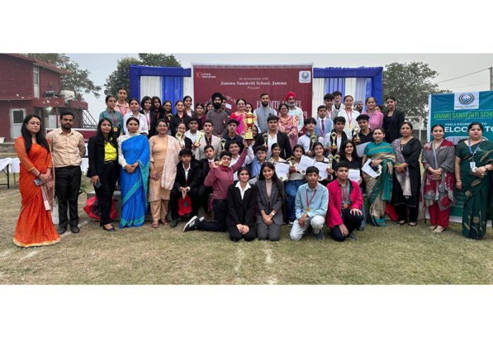 Delegates of different schools posing along with dignitaries during MUN conference.